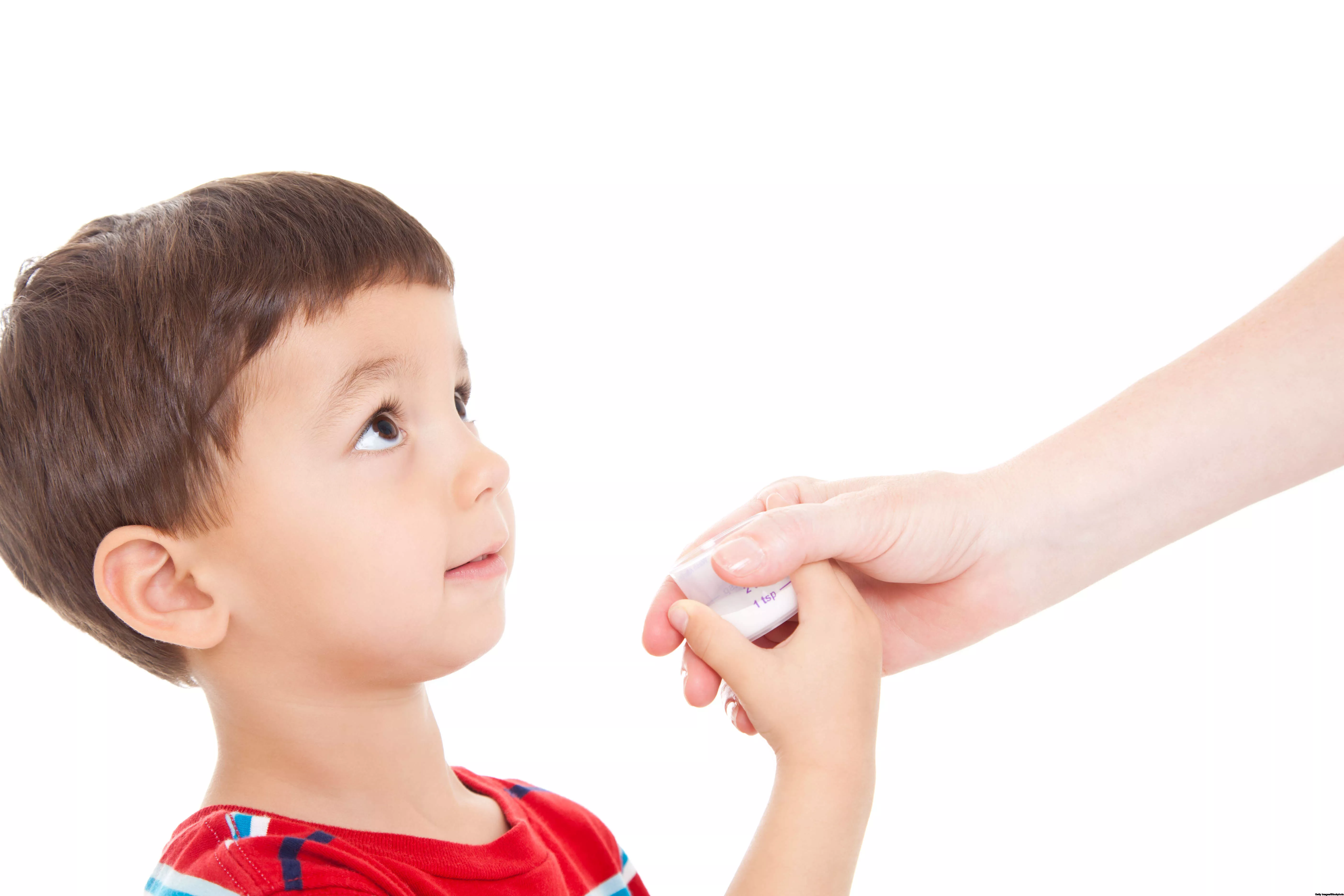 A kid is given a cup of syrup